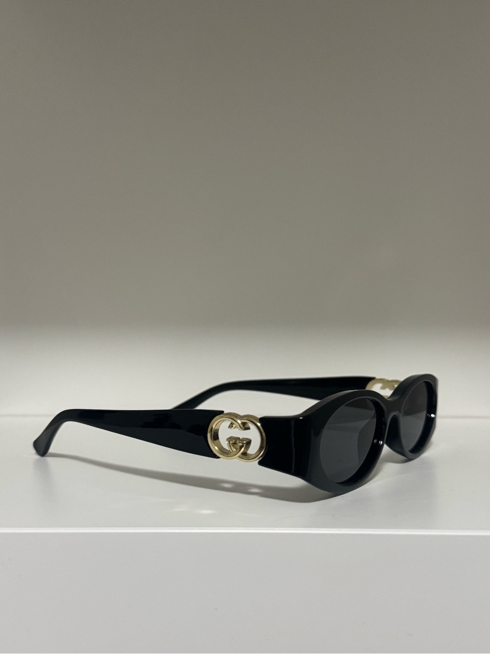 Gucci Black Oval Sunglasses with Gold Double G Emblem